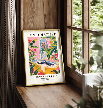 Framed bathroom artwork featuring a shark in a tub with lush greenery and pink flowers.